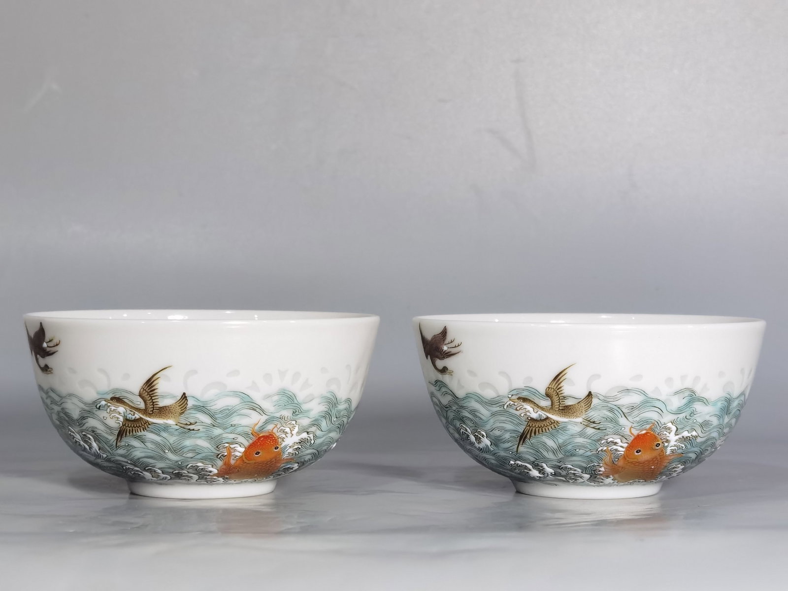 A Pair of Exquisite Famille-Rose Seawater and Fish Pattern Cups: A Pair of Exquisite Famille-Rose Seawater and Fish Pattern Cups,Qing Dynasty,China,Qianlong Six-character Mark,Size:3.3inx1.7in 一对粉彩海水鱼纹杯
