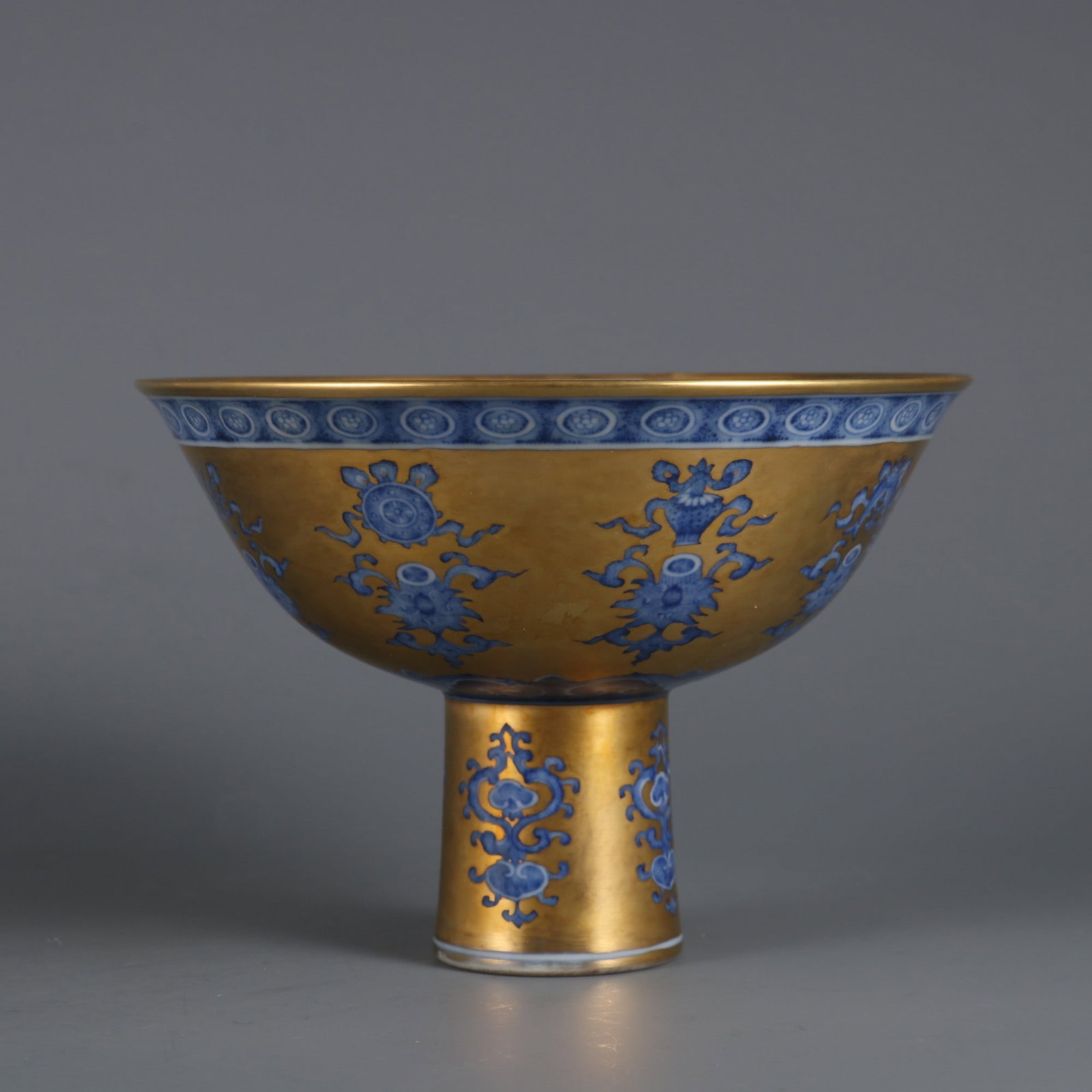 An Exquisite Gold Ground Blue and White Lotus and Eight Treasures Pattern Stem Bowl: An Exquisite Gold Ground Blue and White Lotus and Eight Treasures Pattern Stem Bowl,Qing Dynasty, China,Yongzheng Six-character Mark,Size:4.3inx6.2in金地青花缠枝