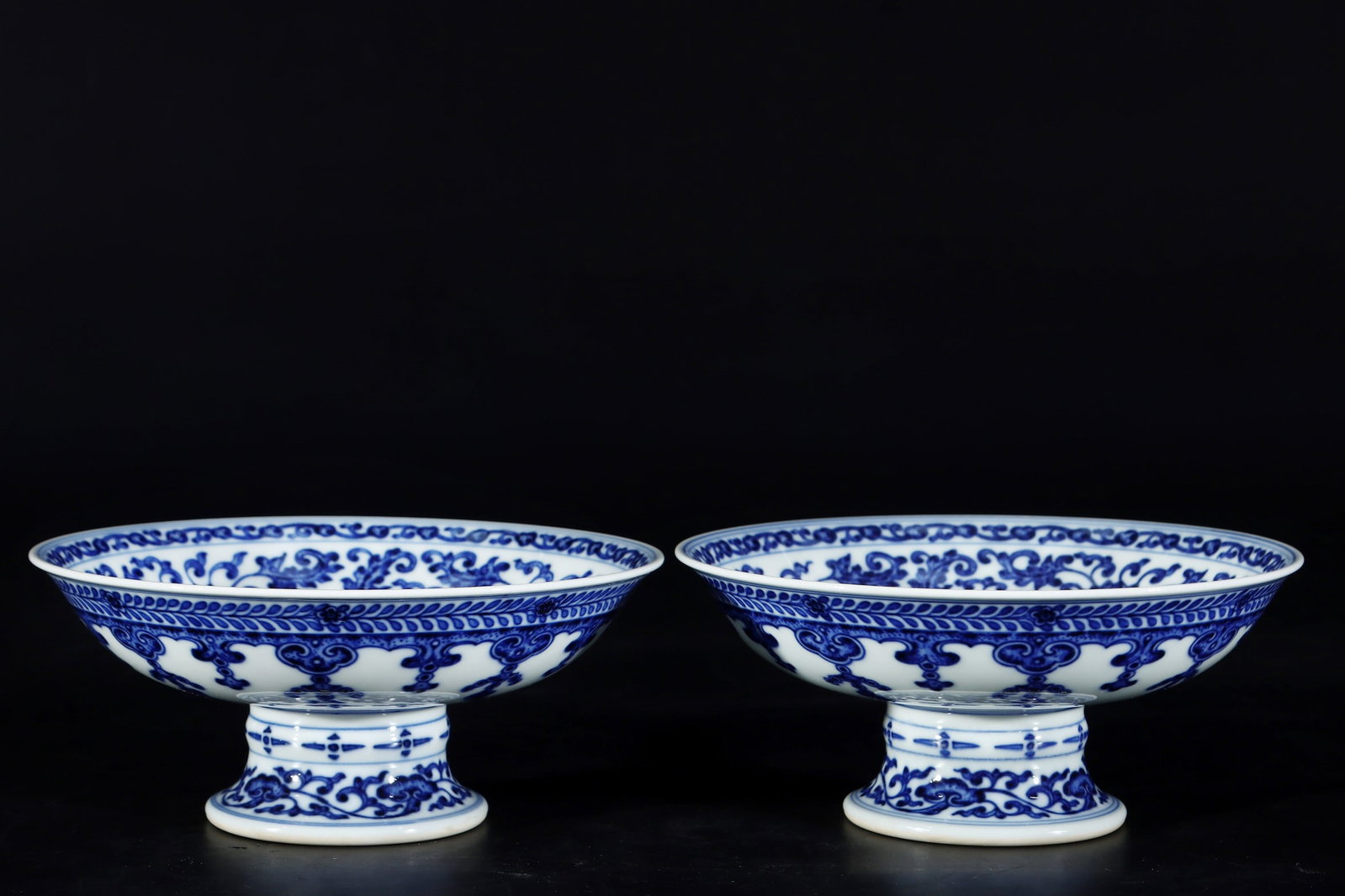 A Pair of Exquisite Blue and White Lotus Pattern Stem Plates: A Pair of Exquisite Blue and White Lotus Pattern Stem Plates,Qing Dynasty, China,Qianlong Six-character Mark,Size:3.1inx6.8in一对青花缠枝莲纹高