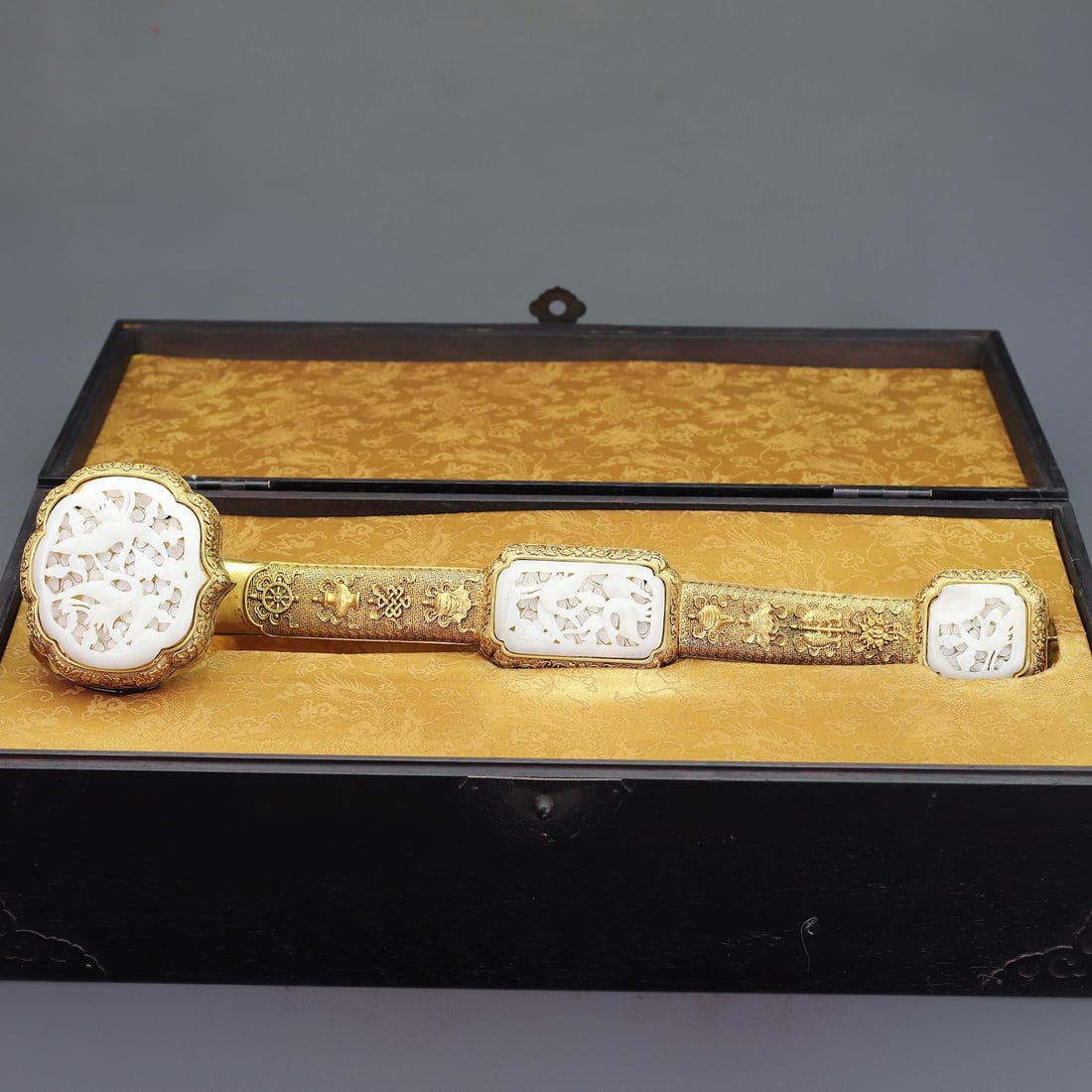 A Huge Gilt Bronze Inlaid White Jade Eight Treasures and Crane Pattern Ruyi: A Huge Gilt Bronze Inlaid White Jade Eight Treasures and Crane Pattern Ruyi,Qing Dynasty,China,Size:(Box)11.6inx20.9inx9.1in,(Ruyi)18.5inx3.9in,Total Weight:5585g铜鎏金镶௙