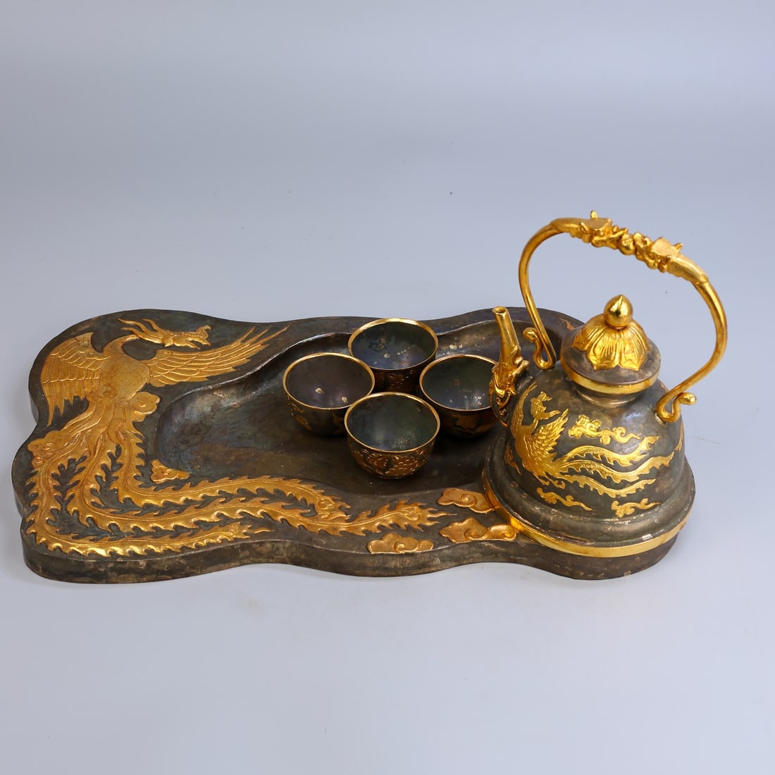 A Set of Rare Gilt Bronze Phoenix Pattern Teawares: A Set of Rare Gilt Bronze Phoenix Pattern Teawares,Qing Dynasty,China,Size:9.4inx17.3in,(Flagon)8.7inx6.7in,(Libation