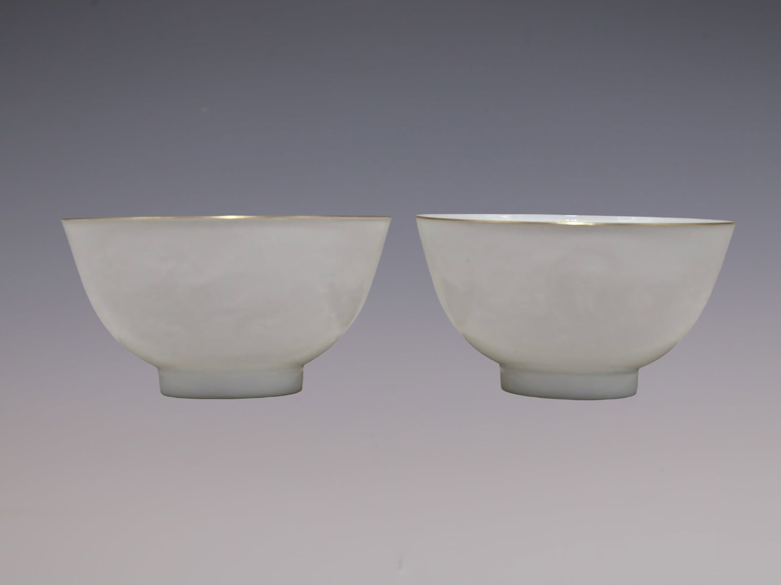 A Pair of Exquisite White Glazed Painted Gold Seawater,Auspicious Cloud and Dragon Pattern Cups: A Pair of Exquisite White Glazed Painted Gold Seawater,Auspicious Cloud and Dragon Pattern Cups,Qing Dynasty, China,Yongzheng Four-character Mark,Size:2inx3.5in一对白釉描