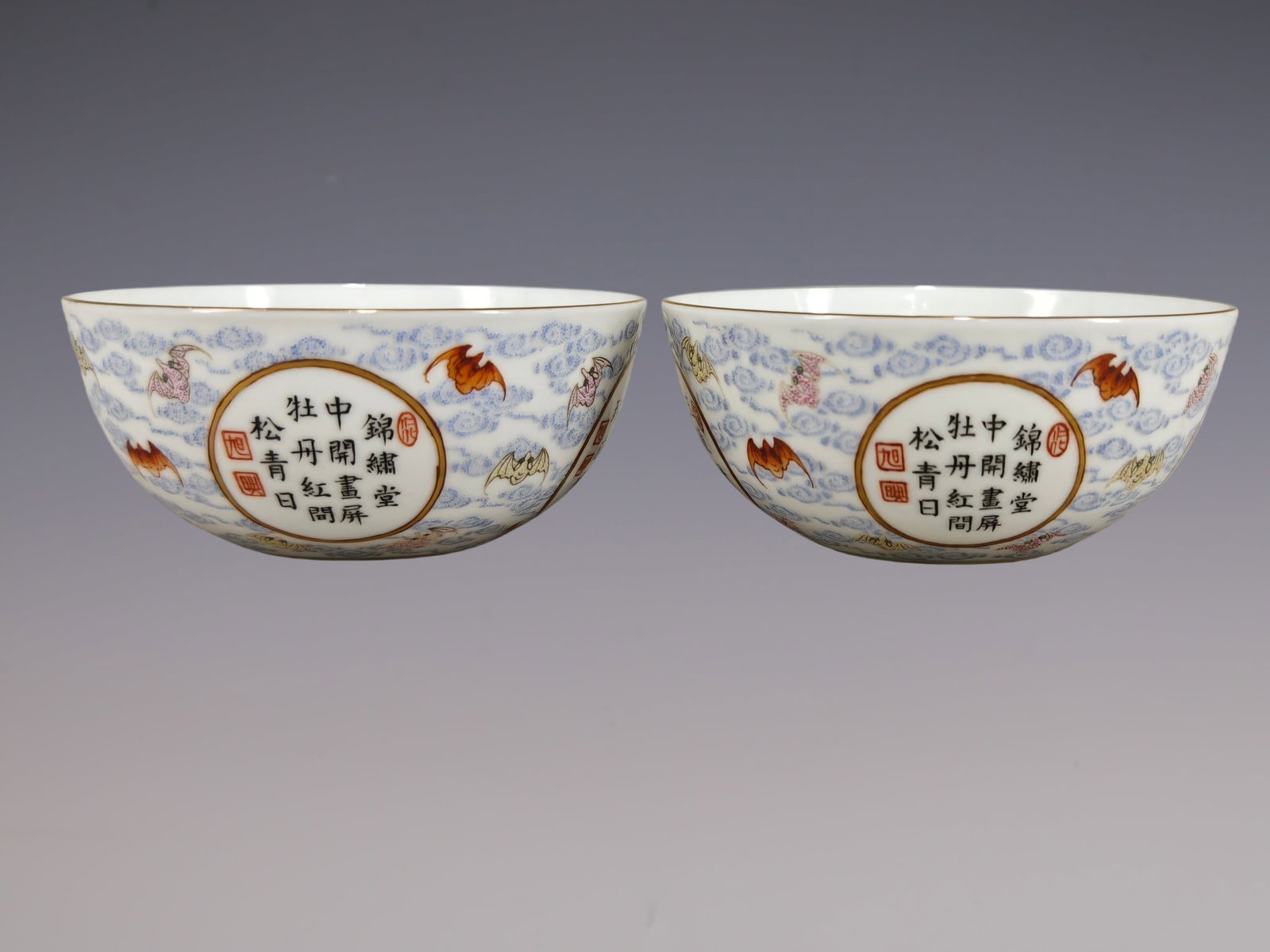 A Pair of Exquisite Famille-Rose Painted Gold Auspicious Cloud and Bats Pattern Cups,With Poem: A Pair of Exquisite Famille-Rose Painted Gold Auspicious Cloud and Bats Pattern Cups,With Poem,Qing Dynasty, China,Qianlong Six-character Mark,Size:1.4inx3.3in一对粉彩描&