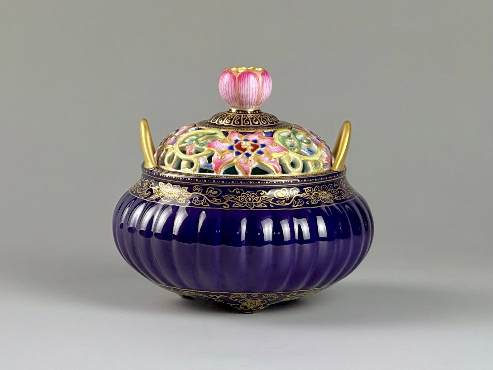 An Exquisite Purple Glazed Famille-Rose Painted Gold Hollow Lotus Pattern Double-Ears Tripod Censer: An Exquisite Purple Glazed Famille-Rose Painted Gold Hollow Lotus Pattern Double-Ears Tripod Censer,Qing Dynasty,China,Qianlong Four-character Mark,Size:3.3inx3.5inx1.7in紫釉粉ঊ