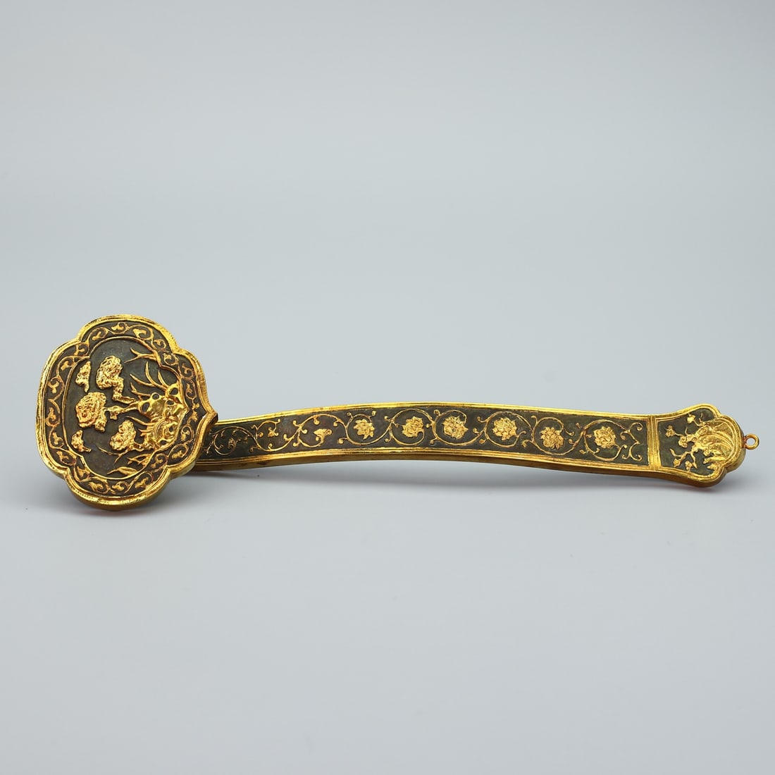 A Rare Gilt Bronze Flower Pattern Ruyi: A Rare Gilt Bronze Flower Pattern Ruyi,Qing Dynasty,China,Qianlong Four-character Mark,Size:13.2inx3.6in,Weight:370g铜鎏金花卉纹如意，中