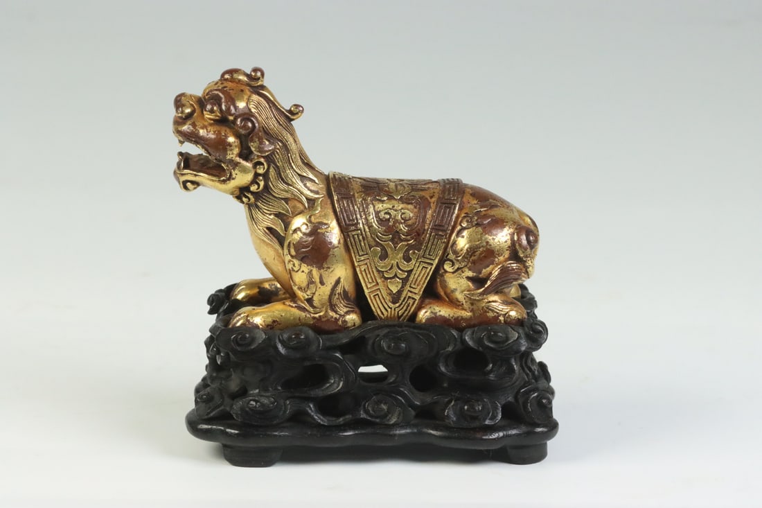 An Exquisite Gilt Bronze Auspicious Beast Ornament,With Zitanwood Base: An Exquisite Gilt Bronze Auspicious Beast Ornament,With Zitanwood Base,Qing
