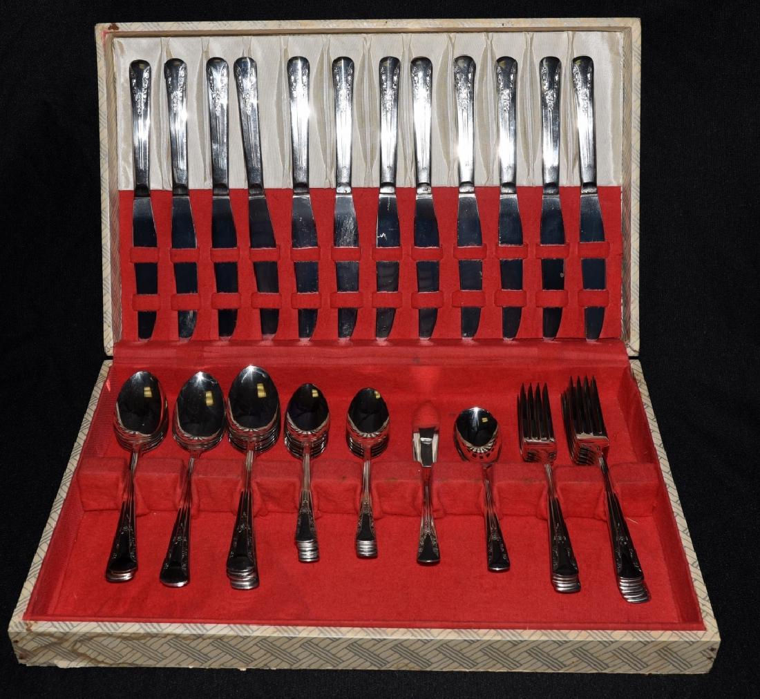 50 Pieces Camelia Silverplate by International: Service for 12 inc. dinner knife, dinner fork, teaspoon, place spoon, master butter and sugar.