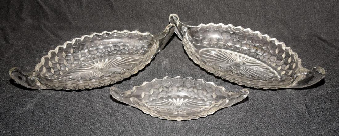 3 Fostoria American Relish Boats: Two #167 relish boats, 1915-82, 12" long and one#166 relish boat, 1915-82, 9" long.