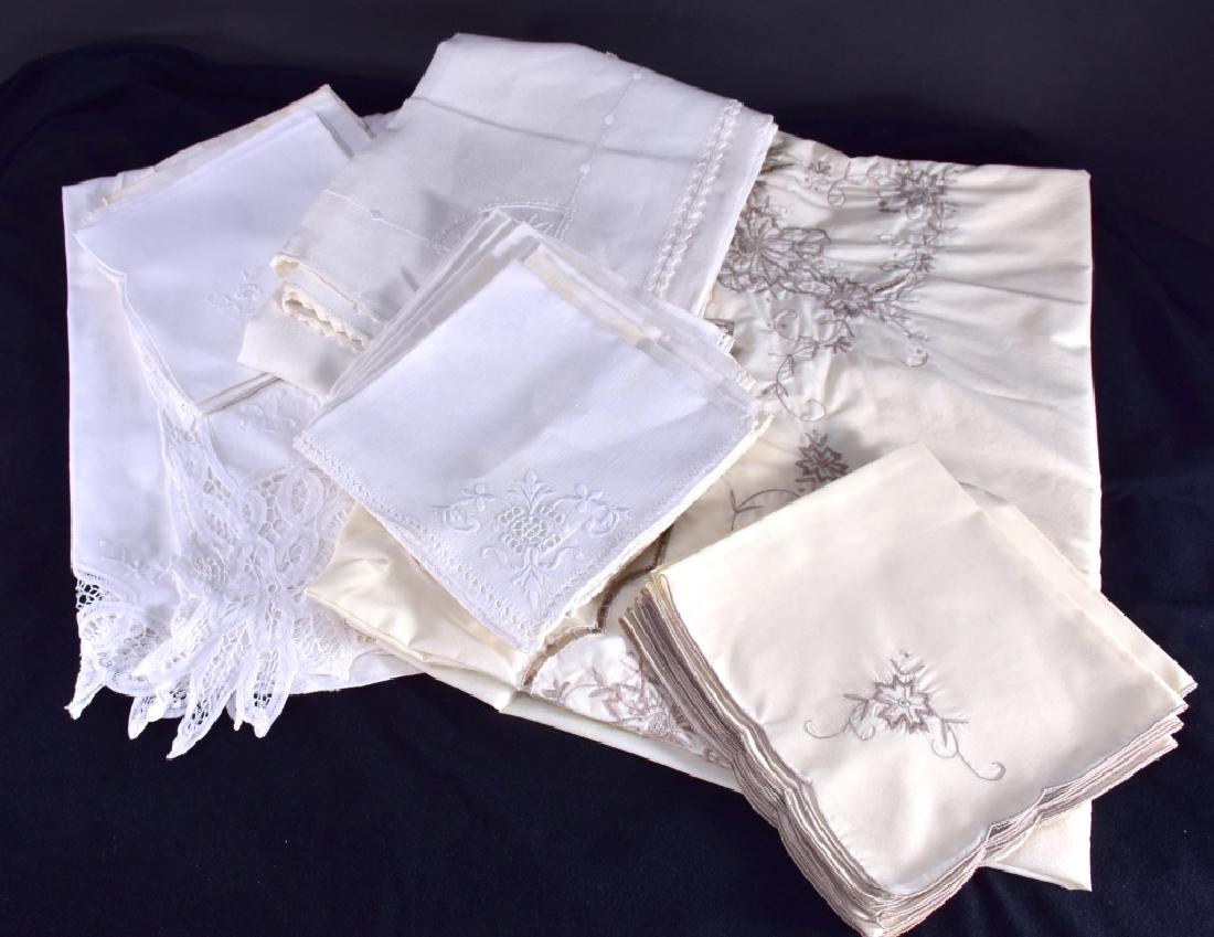 Three White & Cream Tablecloths & Napkins: One embroidered linen cloth 42" x 57", white embroidered cotton cloth 41" x 58" and cream cloth 68" x 82" & 11 napkins together w/set 16 napkins and set 6 napkins (some w/stains).