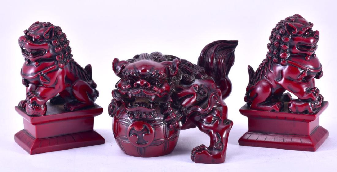 Three Composite Foo Dogs: One male w/both paws on ball 5" long and two (a true pair) on stands male w/paw on ball and female w/paw on pup, 4.25" tall.