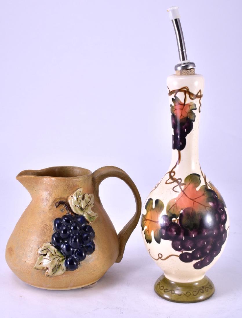 Grape Decorated Ceramic Pitcher & Oil Bottle: Pitcher w/3-dimensional grapes signed & dated 2004, 6" tall and oil bottle 14" tall.