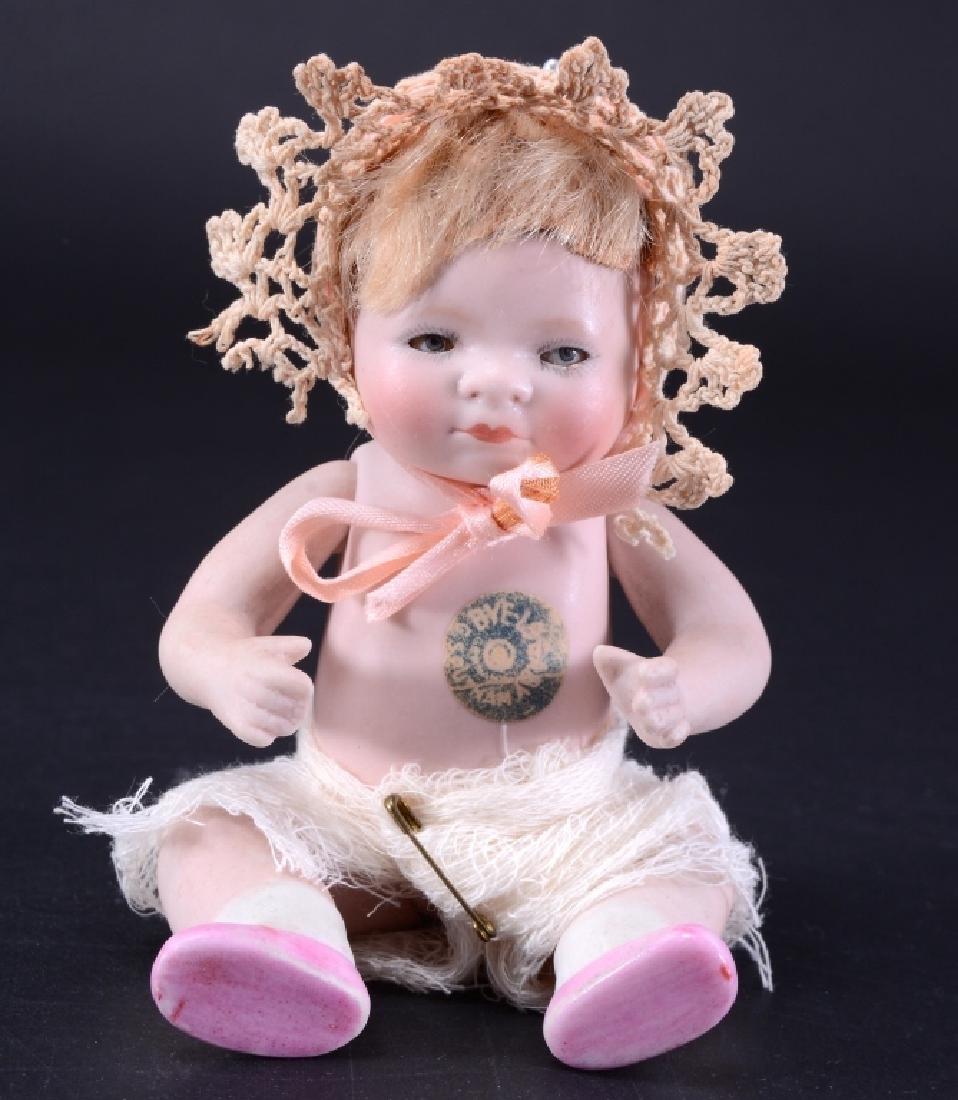 Repro Grace S. Putman Germany Doll: Eyes: glass, stationary. Body: porcelain. Hair: mohair. Head: porcelain. Clothing: gauze diaper. 6" tall. VCG. As found.
