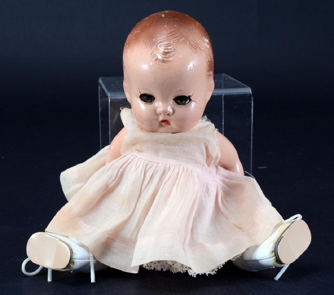 Effanbee Patsy Baby Doll: Eyes: brown. Body: composition. Hair: painted. Head: composition. Clothing: dress, good. 8" tall. G. As found.