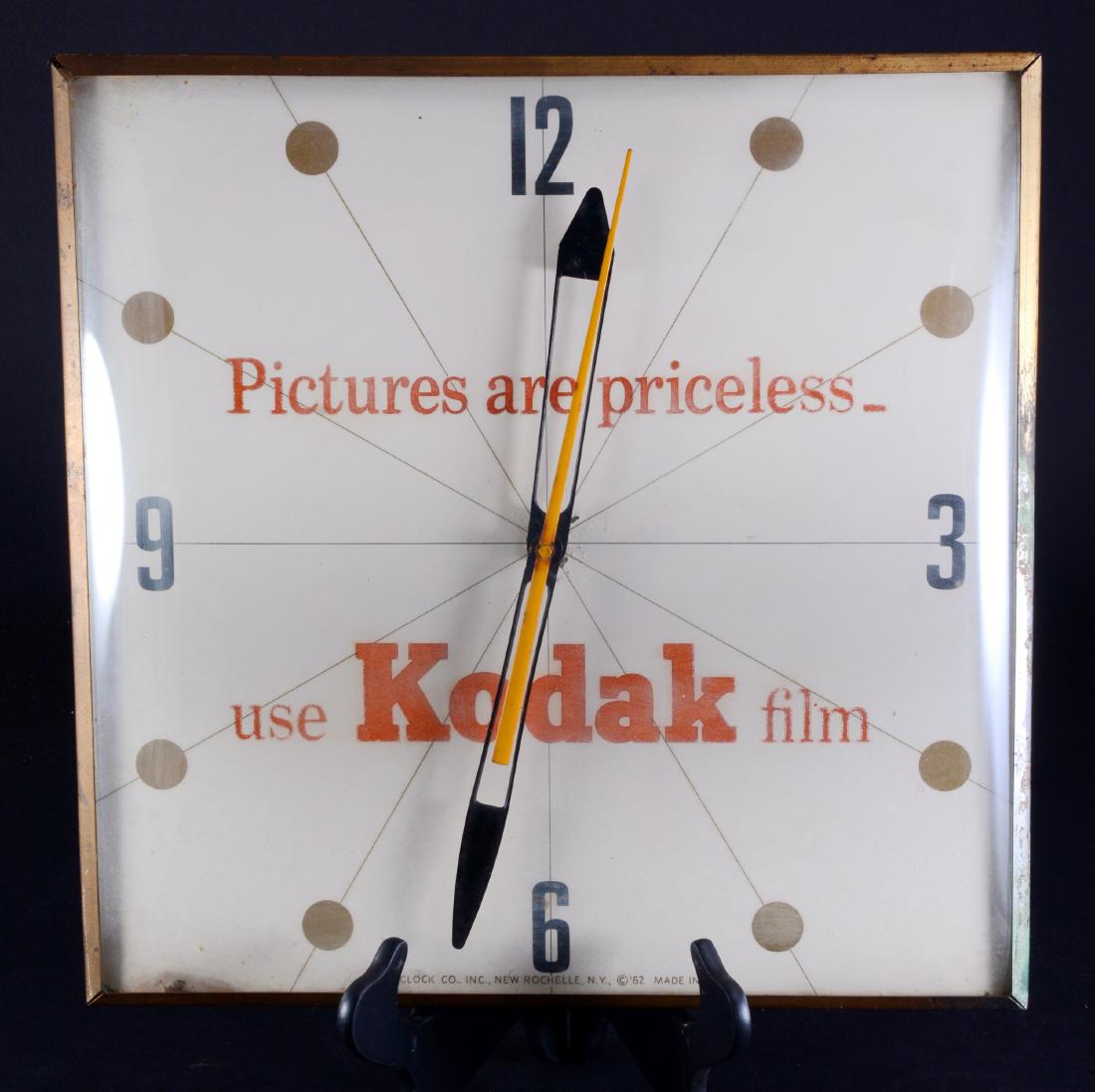 Kodak "Pictures Are Priceless" Electric Wall Clock: Eastman Kodak Co., 6.5" tall x 3.5" wide.