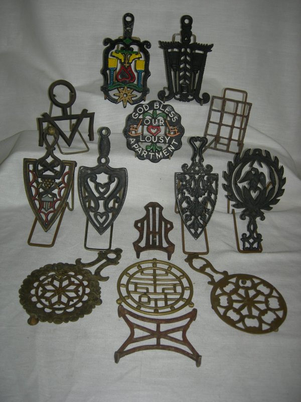 14 Trivets: 14 Trivets in Sizes Ranging From 3.5" Long to 8.75" Long Including 3 Spade Shapes; 3 Brass.