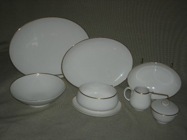 CHINA: Noritake Ivory w/Gold Trim Dignatio China Marked 7523, Serving Pieces Inc. 2 Oval Platters, 12.5"L & 15"L; Oval Vegetable Server, 8.75"L; Round Bowl, 8.75"D; Gravy Boat w/Attached Saucer, 8"L; Creamer