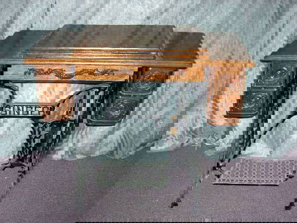 ANTIQUE SINGER SEWING MACHINE CABINET & MACHINE: Antique Singer Sewing Machine Cabinet With Sewing Machine, Shallow Center Drawer To Hold Notions, 4 Small Drawers At Sides, Decorative Carving, Singer Logo On Working Metal Treadle, 36"W X 18"Deep X 3