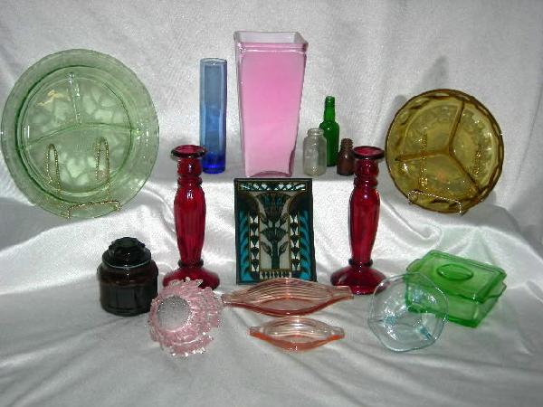 COLORED GLASS LOT: Colored Glass Lot Inc. Pink Vase, 0"T; Blue Bud Vase; 3 Miniature Bottles, 2.25"T – 4.75"T; Pair Red Candlesticks, 9"T; 2 Divided Dishes, 8"D & 10.5"D; Brown Canister; Free From Ice-Look Pink Bowl; 