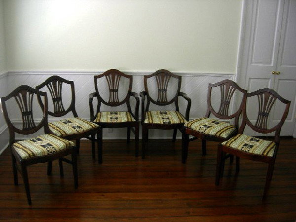 SET OF 6 HEPPLEWHITE STYLE DINING CHAIRS: Mahogany Federal Style Dining Chairs Including Two Arm (37" Center Back Height) and Four Side Chairs w/Shield Shaped Backs, Pierced Splats, Drop-in seats Upholstered in Classical Pattern, Side Stretch