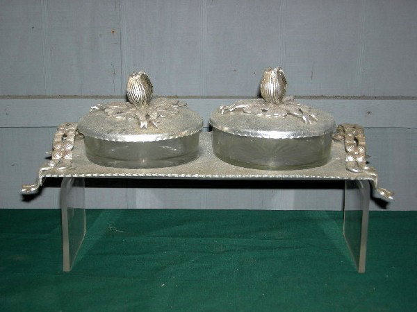 ALUMINUM DRESSER SET: Two Glass Dishes w/Aluminum Lids on Aluminum Stand. Classic Rodney Kent design w/Ribbon and Flowers, 13.5" Wide.