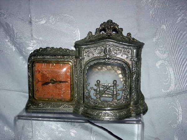 UNITED CLOCK W/FIREPLACE: United Clock, Ornate Metal Body, 11.5" Wide x 8.5" Tall.