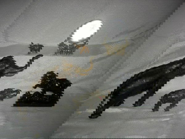 ELEPHANT LOT: 5 Elephants Including Metal Delaware Water Gap Pennsylvania Large and Small Elephants, 10" and 4.5" Long; Cast Iron Elephant Stomping Prey, 5.25" Long; Orb w/Brass Holder w/Three Elephants; Small Bras