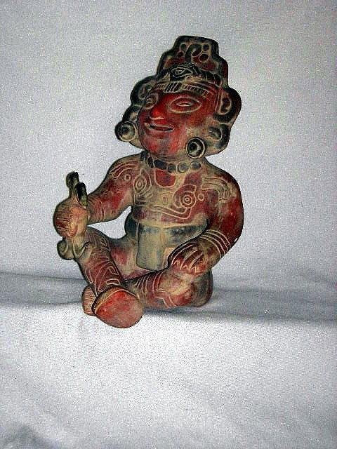 PRIMITIVE CLAY SCULPTURE: Primitive masked figure, seated, marked Mexico, 13"T.
