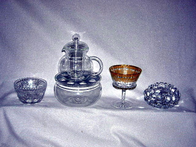 EUROPEAN GLASS LOT INC. CRYSTAL: European Glass & Crystal Inc. Small Bowl Made in Germany, 2.25"T; Jenaer Tea Pot on Warmer Made In Germany, 9"T; Two Spode Champagne Glasses, Made in England, 4.5"T; Orrefors Candle Holder, Sweden, 2.