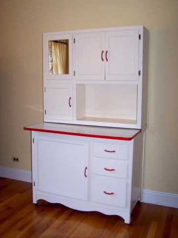 HOOSIER CABINET: White Cabinet with red trim, mirror, sifter, flour bin; 40" W x 25.25" D x 68.25" T.