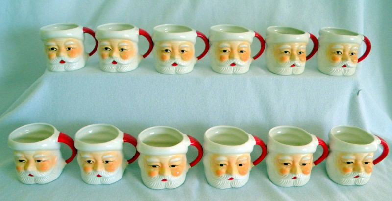TWELVE CHRISTMAS MUGS: A Dozen Ceramic Santa Mugs Marked Japan, White w/Red Handle, 2.75" T.