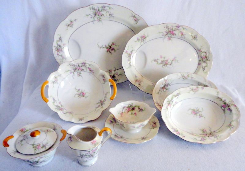 HAVILAND CHINA SERVING PIECES: Theodore Haviland "Rosalinde" Rose bouquet on Ivory w/Gold Scalloped Rim, Inc. 2 Serving Platters, 2 Vegetable Bowls, Tab Handled Serving Bowl, Gravy Bowl w/Attached Plate, Creamer & Covered Sugar.