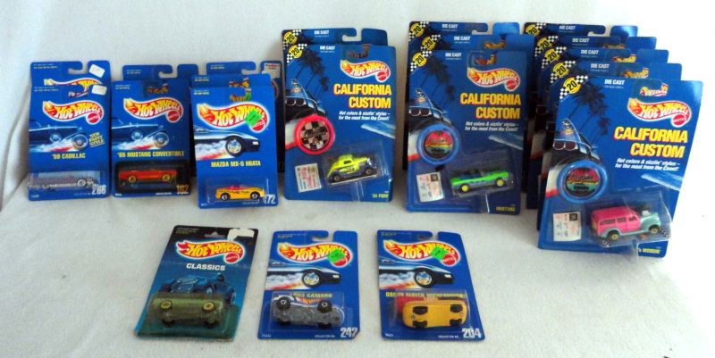 HOT WHEELS CARS: 20 Mattel Hot Wheels Die Cast & Plastic Cars MIB Inc. 9 Cobras, 3 '65 Mustang Convertibles, 2 '40's Woodies, 1 '34 Ford, 1 Swing Fire, 1 '57 Chevy and 1 Ambulance.