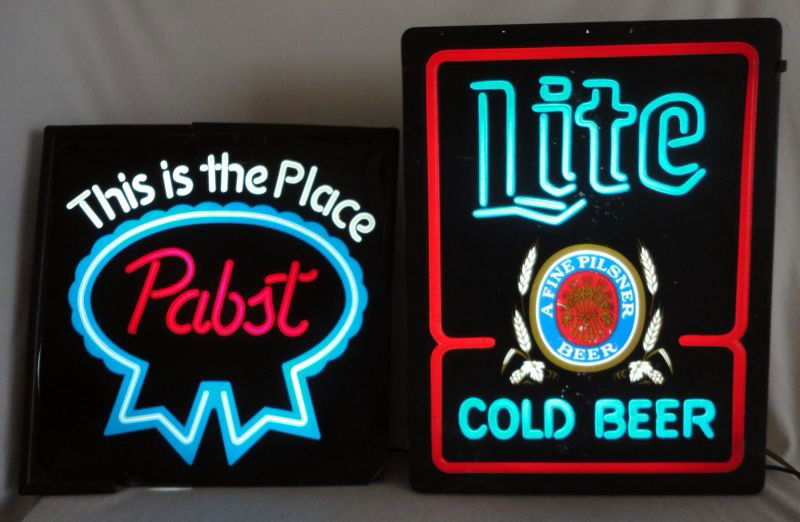 TWO NEON ADVERTISING BEER SIGNS: Two Neon Advertising Beer Signs "Lite A Fine Pilsner Beer, Cold Beer" (Blue & White Letters On Black Background), 15"W X 19"T; "This Is The Place Pabst" (White & Red Letters, Encircled w/Blue Ribbon O