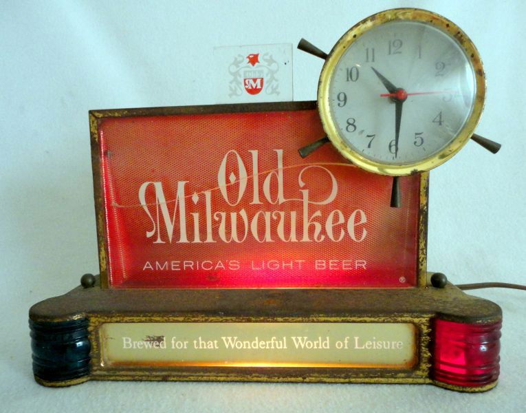 OLD MILWAUKEE ADVERTISING CLOCK: "Old Milwaukee America's Light Beer Brewed For That Wonderful World Of Leisure" Electric Lighted Sign/Clock, 10"W X 8"T.