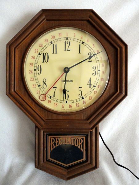 REGULATOR WALL CLOCK: Regulator Electric Wall Clock, Brown w/Letter Octagon On White Clock Face, 13"W X 18.25"T.