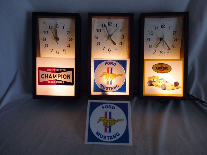 THREE WOOD FRAMED ADVERTISING CLOCKS: 3 Hand Assembled Electric Lighted Advertising Clocks w/"Lanshire Synchronous Self Starting Electric Clock Movement" Inc. 1 "Supreme Quality Pennzoil Safe Lubrication," 1 "Ford Mustang," & 1 "Equipped