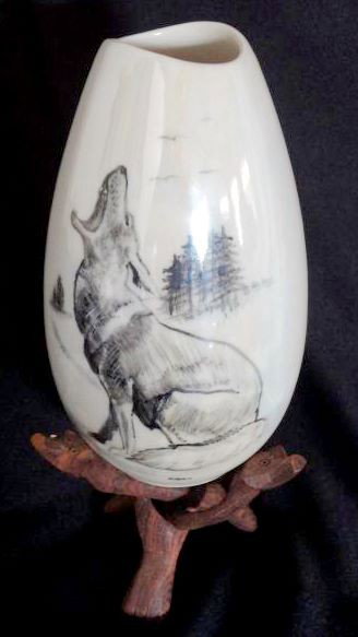 BERING SEA HAND PAINTED VASE: Oval Shaped Signed Ceramic Vase (7.5" T) with Shaped Opening Pictures Howling Wolf Amid Trees, Iridescent Glaze, Russian. Together w/Wooden Puzzle Stand.