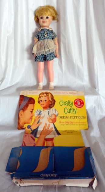 LITTLE MISS SUNBEAM & CHATTY CATHY ADVERTISING: Lot Includes Doll w/Miss Sunbeam on Apron, 17" T Together w/Mattel Chatty Cathy Dress Pattern Advertising, 13.5" W x 17" T.