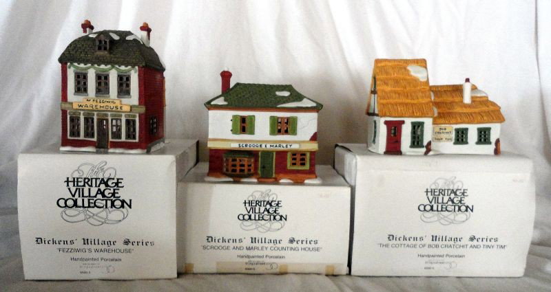 THREE DEPT 56 DICKENS' VILLAGE SERIES: Hand Painted Porcelain Dickens' Village Series Inc. "Scrooge And Marley Counting House", 6.5"T.; "Fezzwig's Warehouse", 7"T.; & "The Cottage Of Bob Cratchit And Tiny Tim", 5"T., w/Original Boxes & Lig