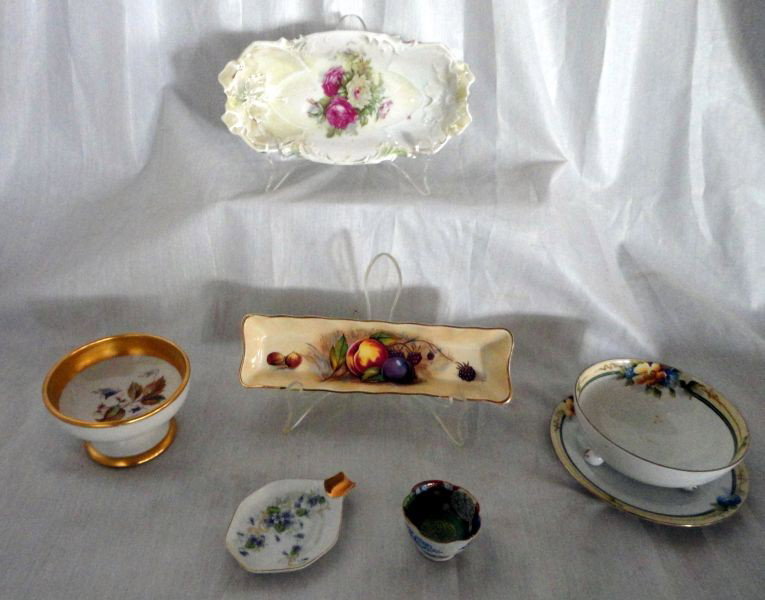 PORCELAIN COLLECTIBLES FROM AROUND THE WORLD: Lot Includes Noritake Mayonnaise w/Underplate, Three Ball Feet, Green Mark, Bowl 4.5" D; Aynsley Relish, 8" L; German Relish w/Minor Edge Chip, 8" L; Unmarked Pedestal Dish w/Wide Gold Rim, Leaf & Flo