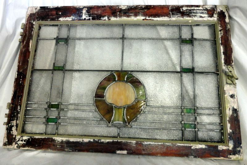 STAINED GLASS WINDOW: English Stained Glass Window, Yellow & Green, Circular Design w/Tree Form Surrounded By Pebble & Green Glass In Plaid Pattern, Framed w/ Painted Wood, Latch & Hinge Hardware, 36”W X 24.5”T.