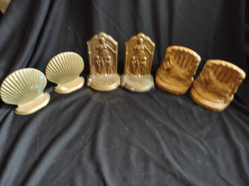 BOOKEND LOT: Lot Includes Three Sets Bookends: Metal Caritas Bookends Marked JB 2540, Ceramic Scotty at the Gate Bookends; and Brass Shell Bookends. 5" to 6.5" T.