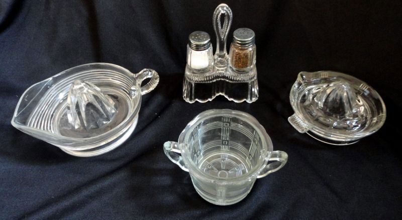 KITCHEN GLASS LOT: Lot Includes 2 Reamers, 5.5” to 6.5” D and an Open Sugar, 3” T; 2 Press Glass Shakers That Fit Into a Double Bell Shaped Glass Holder, 6.25"T.