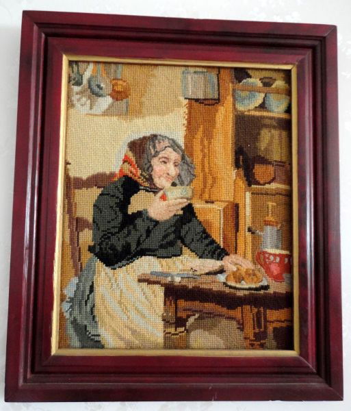 FRAMED NEEDLEPOINT OF WOMAN IN KITCHEN: Needle Point & Petit Point Features Old Woman at Kitchen Table, Cherry Finish Frame, 19.5" T x 16.5" W.