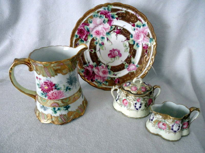 HAND PAINTED NIPPON LOT: Porcelain Lot Includes Pitcher, 6.75" T; Serving Plate, 10.25" D; Open Creamer & Covered Sugar. All Pieces Marked. White Ground w/Flowers and Heavy Gold.