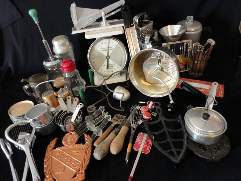 VINTAGE KITCHEN LOT: Including: 2 Scales, Acme Egg Grating & American Family 25 Lbs., 3 Graters, 3 Thermometers, Measuring Cups & Spoons, 3 Trivets, Canning Tongs, Tea Ball, Aluminum Shaker, Peculator, Nut Crackers & Pick