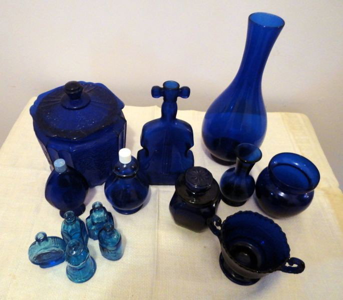 BLUE GLASS LOT: Lot Includes Mayfair Open Rose Covered Biscuit Jar, 7" T; Violin, 8" T; Bulbous Vase, 11" T, 2 Small Vases, Double Handled Cup, Bourjois and Avon Capped Bottles, Covered Candle and 5 Aqua Miniatures.