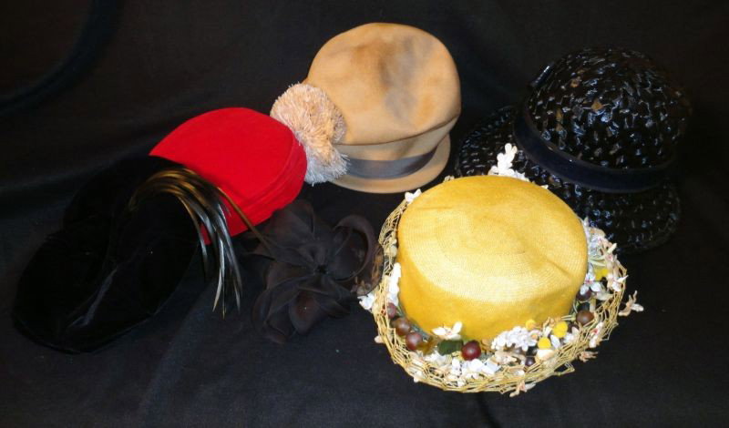 VINTAGE HAT LOT: Inc. Blue Woven; Tan Wilshire Woven w/Floral & Fruit; Tan Peach By Henry Pollack w/Pom Pom; Handrolled Hat-lot in Original Box; 2 Velvet Hats 1 Black w/Applied Feather Brush & Red Pill Hat w/Hat Pins.