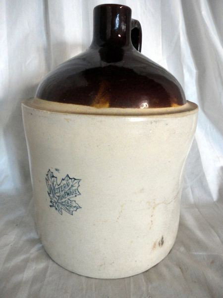 WESTERN STONEWARE CROCK JUG: Tan w/Rounded Brown Top & Handle, Stamped Maple Leaf Enclosing Words "Western Stoneware,9"D X 12.5"T.