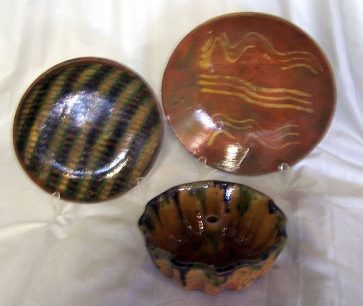 REDWARE LOT: 3 Pieces Including: 7"D Turks Head Cake Mold w/Green & Brown Glaze; 9.75"D Plate, Coggled Edge w/Yellow Slip Decorated; 8"D Shallow Bowl w/Slip, Green & Black Glaze Stripe Design.